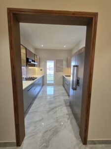 “Modern modular kitchen at Hare Krishna Ashiyana in Vrindavan with stylish cabinets, ample storage, and premium finishes”