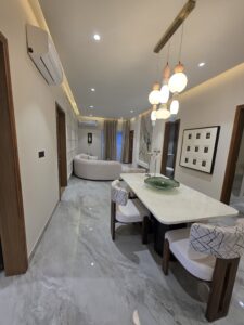 “Spacious living room at Hare Krishna Ashiyana in Vrindavan with modern interiors, elegant lighting, and premium finishes”